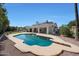 Backyard pool with a diving board and a covered patio, surrounded by landscaping at 1454 E Calle De Arcos --, Tempe, AZ 85284