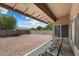 Enjoy this backyard with stone ground cover and a covered patio with seating, perfect for relaxing outdoors at 14821 W Honeysuckle Ln, Surprise, AZ 85374
