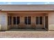 This covered patio features neutral walls, a tiled roof, and comfortable seating, ideal for outdoor living at 14821 W Honeysuckle Ln, Surprise, AZ 85374