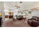 Bright living room boasts vaulted ceiling, fan, and open layout, seamlessly connecting the living space to the kitchen at 14821 W Honeysuckle Ln, Surprise, AZ 85374