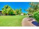 This lovely common area features mature shade trees and lush landscaping at 1550 N Stapley Dr # 95, Mesa, AZ 85203