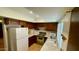 Well-lit kitchen with white appliances and classic wood cabinetry at 1550 N Stapley Dr # 95, Mesa, AZ 85203