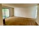 Bright living room featuring neutral walls, carpet, and a sliding glass door at 1550 N Stapley Dr # 95, Mesa, AZ 85203