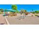 This playground features a swing set, tables, and shade canopies at 1550 N Stapley Dr # 95, Mesa, AZ 85203