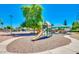 This community playground features a play structure, benches, and mature trees at 1550 N Stapley Dr # 95, Mesa, AZ 85203