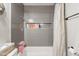 Stylish bathroom with tiled shower featuring a built-in niche. Modern towel bar and fixtures at 17634 N 34Th Ln, Phoenix, AZ 85053