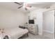 Cozy bedroom with ceiling fan and TV on dresser. Features tiled flooring and a neutral color scheme at 17634 N 34Th Ln, Phoenix, AZ 85053