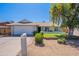 Charming single-story home featuring a well-maintained front yard with mature trees and a white mailbox at 17634 N 34Th Ln, Phoenix, AZ 85053