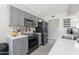 Modern kitchen with grey cabinets, stainless steel appliances, and light countertops. Includes grey backsplash at 17634 N 34Th Ln, Phoenix, AZ 85053