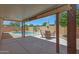 Shaded patio with outdoor dining set, offering a view of the inviting pool area for outdoor enjoyment at 18130 N 92Nd Ln, Peoria, AZ 85382