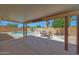 Covered patio overlooking the refreshing pool area and a charming outdoor dining set for relaxation at 18130 N 92Nd Ln, Peoria, AZ 85382