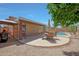 Backyard featuring a covered patio with a dining set, and a pool area, perfect for relaxation at 18130 N 92Nd Ln, Peoria, AZ 85382