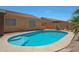 Private backyard with an inviting pool, lush greenery, and a serene atmosphere, ideal for relaxation at 18130 N 92Nd Ln, Peoria, AZ 85382