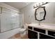 Bathroom with vanity, updated lighting and shower with glass doors at 18130 N 92Nd Ln, Peoria, AZ 85382