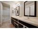 Bathroom with double sinks, framed mirrors, spacious countertop, and a shower/tub combination at 18130 N 92Nd Ln, Peoria, AZ 85382