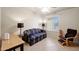 Well lit bedroom with ceiling fan, window, sofa, and reading chair at 18130 N 92Nd Ln, Peoria, AZ 85382