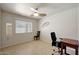 Bedroom with ceiling fan, window, mirror, desk, and decorative wall art at 18130 N 92Nd Ln, Peoria, AZ 85382