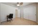 Well lit bedroom features ceiling fan, closet, and doorway to another room at 18130 N 92Nd Ln, Peoria, AZ 85382