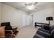 Bedroom with ceiling fan, sofa, storage, and sitting chair at 18130 N 92Nd Ln, Peoria, AZ 85382
