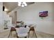 Bright dining area with modern table, white chairs, and ample natural light at 18130 N 92Nd Ln, Peoria, AZ 85382