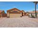 Charming single-story home with desert landscaping, tile roof, and paved driveway at 18130 N 92Nd Ln, Peoria, AZ 85382