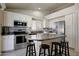 Well-equipped kitchen featuring white cabinetry, stainless appliances and a functional island at 18130 N 92Nd Ln, Peoria, AZ 85382
