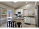 Bright kitchen features stainless steel appliances, breakfast bar, and access to outdoor space at 18130 N 92Nd Ln, Peoria, AZ 85382