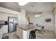 Open kitchen with stainless steel refrigerator, tile flooring, island, and attached breakfast nook at 18130 N 92Nd Ln, Peoria, AZ 85382