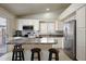 Bright kitchen features stainless steel appliances, breakfast bar, and access to outdoor space at 18130 N 92Nd Ln, Peoria, AZ 85382
