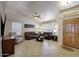 Bright living room with tile floors, vaulted ceilings, a ceiling fan, and lots of natural light at 18130 N 92Nd Ln, Peoria, AZ 85382