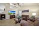 Comfortable living room featuring vaulted ceilings, tile floors and an entertainment center at 18130 N 92Nd Ln, Peoria, AZ 85382