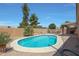 Backyard pool featuring a diving board, gravel landscaping, and privacy fence on a sunny day at 18130 N 92Nd Ln, Peoria, AZ 85382