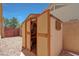 Wooden shed with open doors providing extra storage space in a desert landscape backyard with gravel at 18130 N 92Nd Ln, Peoria, AZ 85382