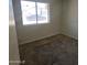 Bedroom featuring window for natural light, worn carpet, and fresh paint at 1843 S Papago Dr, Apache Junction, AZ 85120