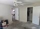 Bedroom with view into the next room and a closet with open doors and storage at 1843 S Papago Dr, Apache Junction, AZ 85120