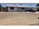 Modest single-story home with low maintenance landscaping, attached garage, and a neutral exterior paint at 1843 S Papago Dr, Apache Junction, AZ 85120