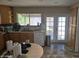 Well-lit kitchen with ample counter space, stainless steel sink, dishwasher, and access to outdoor patio at 1843 S Papago Dr, Apache Junction, AZ 85120