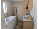 Dedicated laundry room with washer, dryer, storage cabinets, and counter space, needs updating at 1843 S Papago Dr, Apache Junction, AZ 85120