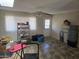 Open-concept living room featuring tile floors, a ceiling fan, and a sliding glass door at 1843 S Papago Dr, Apache Junction, AZ 85120