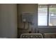 Utility room with water heater, plumbing connections, and a window for natural light at 1843 S Papago Dr, Apache Junction, AZ 85120