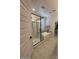 Modern bathroom with glass enclosed shower, separate tub, tile floors and white trim at 18941 W Monterosa St, Litchfield Park, AZ 85340