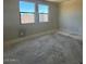 Empty bedroom with two windows and cement flooring at 18941 W Monterosa St, Litchfield Park, AZ 85340