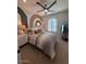 Cozy bedroom with neutral tones, modern fan, and large window at 18941 W Monterosa St, Litchfield Park, AZ 85340