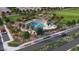 Aerial view of the community pool area with water features, lounge chairs, and ample space for recreation at 18941 W Monterosa St, Litchfield Park, AZ 85340