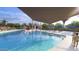Beautiful community pool featuring Gathering-friendly splash pad and ample seating for relaxation at 18941 W Monterosa St, Litchfield Park, AZ 85340