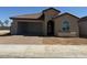 Single-story home with a two-car garage and desert landscaping at 18941 W Monterosa St, Litchfield Park, AZ 85340