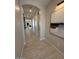 Long hallway featuring an archway and light grey walls at 18941 W Monterosa St, Litchfield Park, AZ 85340