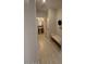 Bright hallway with white bench, coat rack and view into a bathroom with pedestal sink at 18941 W Monterosa St, Litchfield Park, AZ 85340
