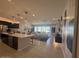 Modern living room with open floor plan, eat-in kitchen, stainless appliances and tile flooring at 18941 W Monterosa St, Litchfield Park, AZ 85340