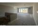 Unfinished living room with large sliding glass doors to the backyard and cement floors at 18941 W Monterosa St, Litchfield Park, AZ 85340